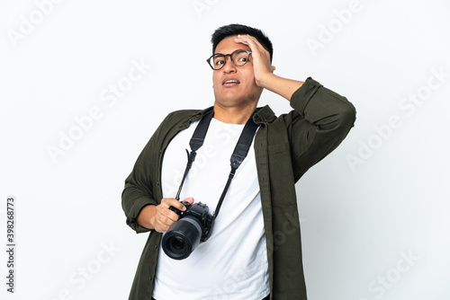 Young Ecuadorian photographer isolated on white background doing surprise gesture while looking to the side