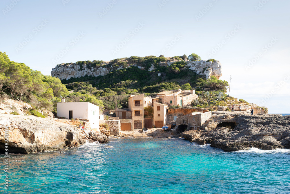 Isolated tinny houses in front of the blue sea in Palma de Majorca, Cala s'almunia