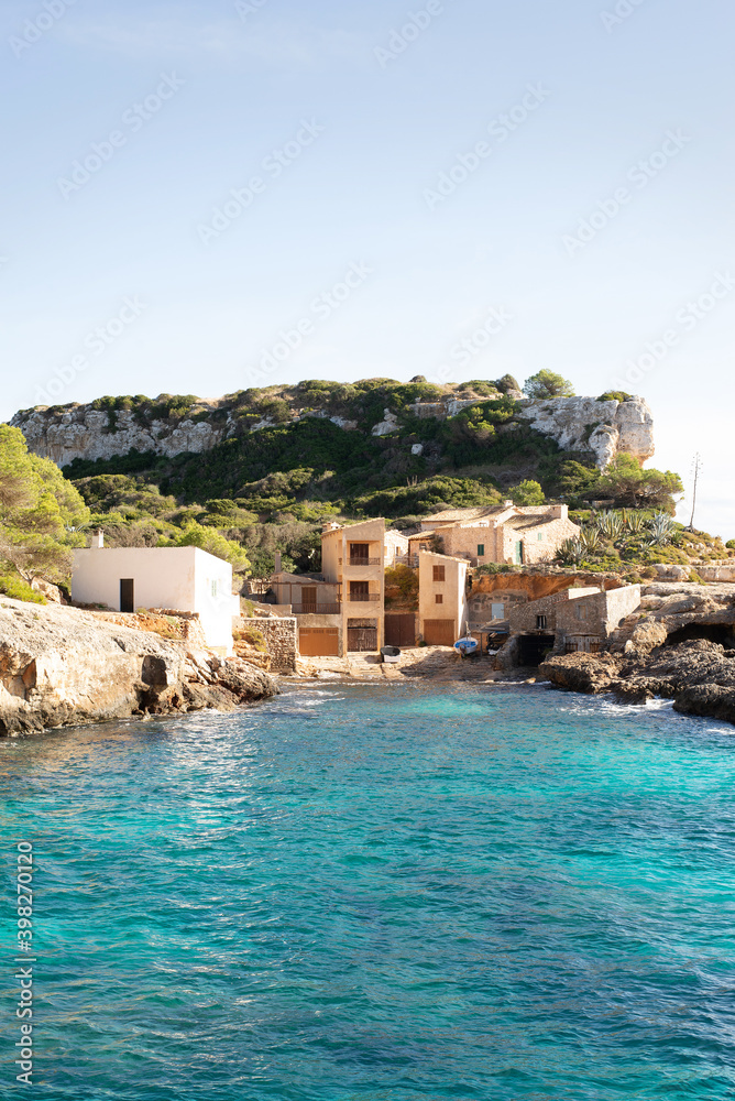 Isolated houses in front of the sea on a sunny day, perfect place for introspection and holidays. Cala s'almunia. Mallorca