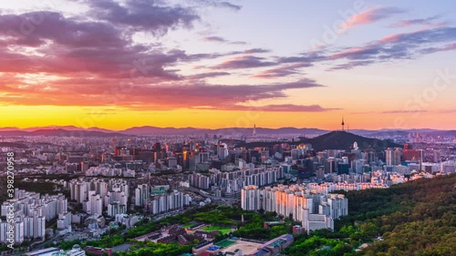 Zoom in, Time lapse 4K Sunrise of Seoul city skyline and Seoul tower modern building and architecture, Beautiful clouds flow through in Seoul, South Korea. photo