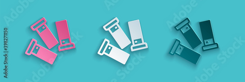 Paper cut Cartridges icon isolated on blue background. Shotgun hunting firearms cartridge. Hunt rifle bullet icon. Paper art style. Vector.