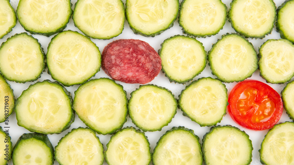 sliced pieces of cucumber and tomato on a white background. fast food and breakfast sliced pieces of cucumber and tomato on a white background. fast food and breakfast