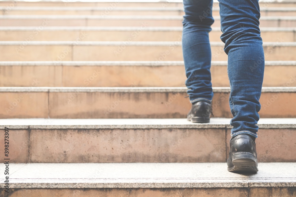 Image of a man walking up the stair. Image of a man walking up the stair.