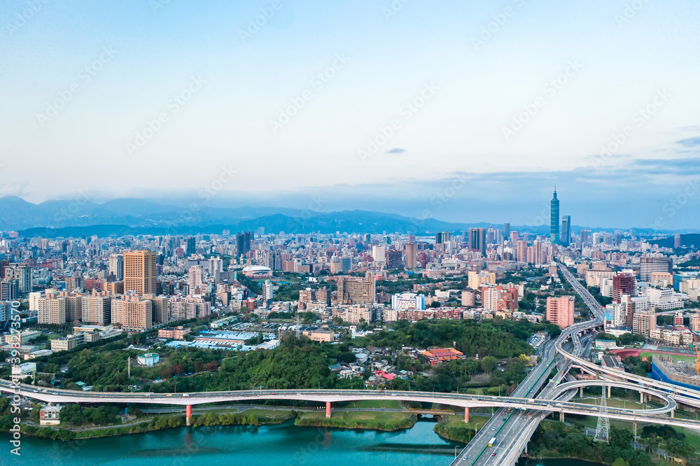 Taipei City Aerial View - Asia business concept image, panoramic modern cityscape building bird’s eye view under sunrise and morning blue bright sky, shot in Taipei, Taiwan