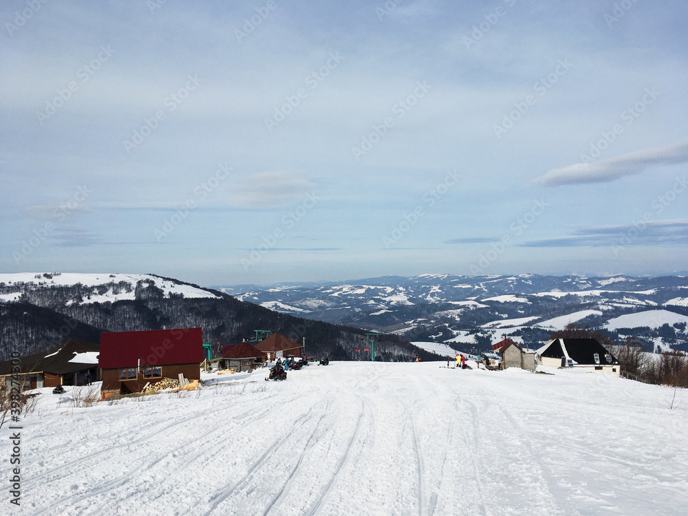 Beautiful natural landscape with mountains covered with snow. Landscape picture of ski resort from top. Active recreation in the mountains. Isolation concept during quarantine. Beautiful natural landscape with mountains covered with snow. Landscape picture of ski resort from top. Active recreation in the mountains. Isolation concept during quarantine.
