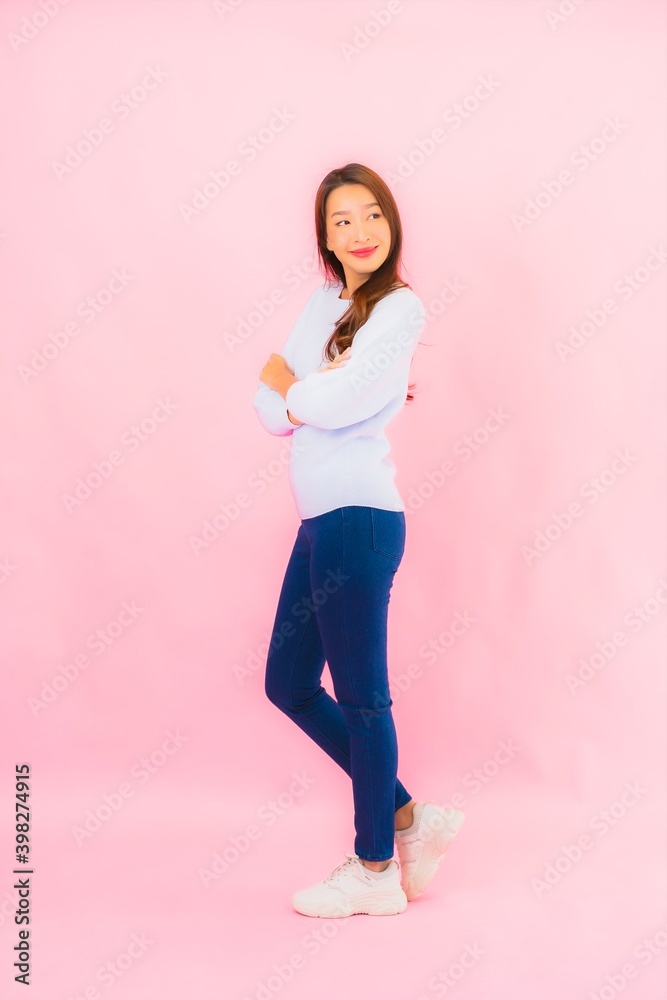 Portrait beautiful young asian woman smile with action on pink background