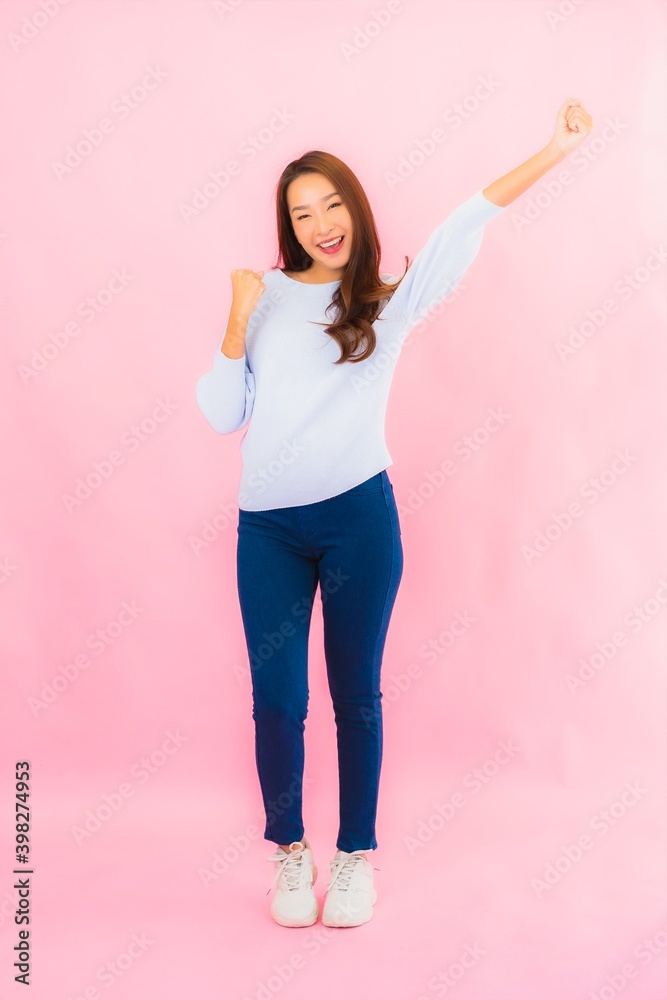 Portrait beautiful young asian woman smile with action on pink background Portrait beautiful young asian woman smile with action on pink background