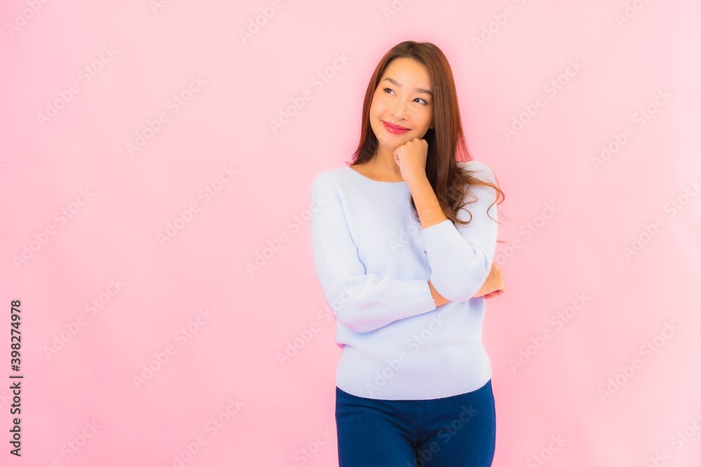 Portrait beautiful young asian woman smile with action on pink background Portrait beautiful young asian woman smile with action on pink background