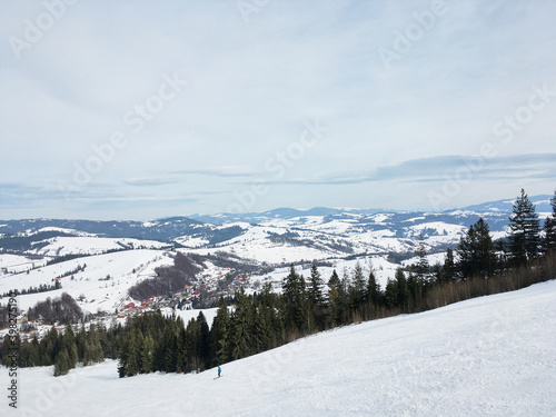 Beautiful natural landscape with mountains and bare trees covered with snow..Ski resort in winter season, Active recreation in the mountains. Isolation concept during quarantine.