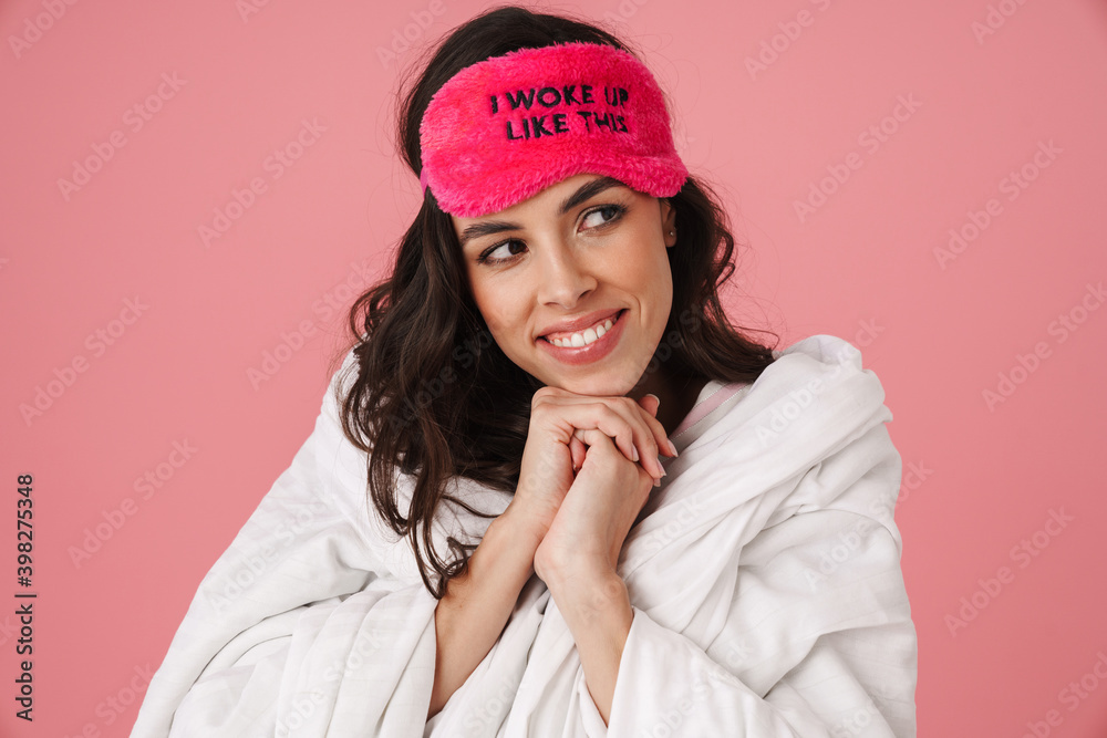 Happy beautiful woman covered in blanket smiling at camera Happy beautiful woman covered in blanket smiling at camera