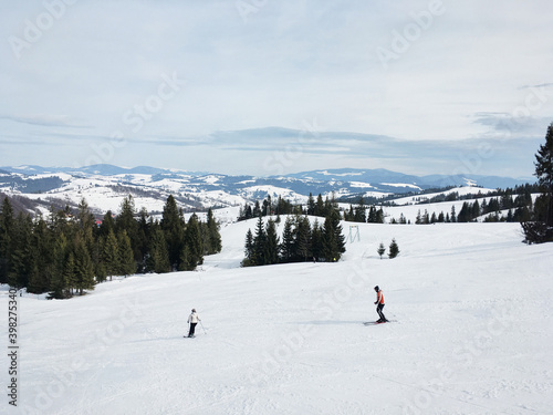 Beautiful natural landscape with mountains and bare trees covered with snow..Ski resort in winter season, Active recreation in the mountains. Isolation concept during quarantine.