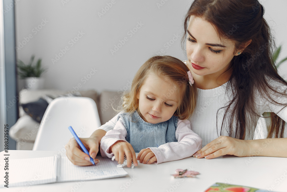 Tutor with pupil. Little girl studying. Private lesson. Mother helps her daughter. Tutor with pupil. Little girl studying. Private lesson. Mother helps her daughter.