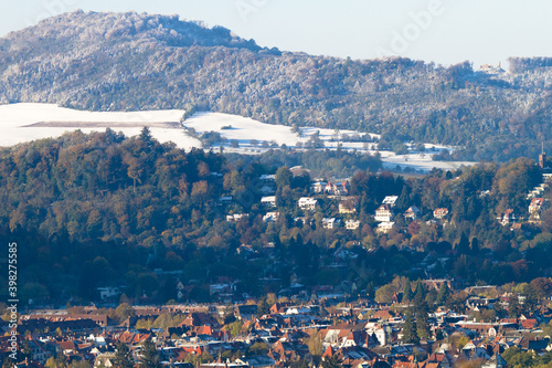 Freiburg im Breisgau/Germany - 11 09 2012: Picturesque view of the city from the mountain, snow-covered Black forest, mountains in the clouds. Early sunny winter morning 