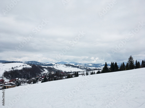 Beautiful natural landscape with mountains and bare trees covered with snow..Ski resort in winter season, Active recreation in the mountains. Isolation concept during quarantine.
