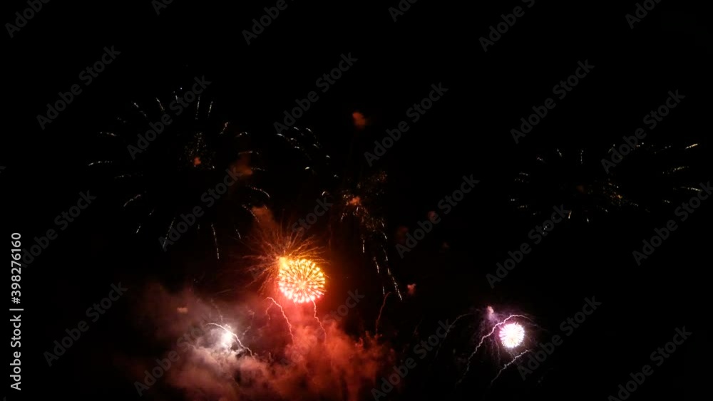 4K loop of beautiful real shining fireworks long shot 49s for celebration background. golden glowing firework during new year's eve countdown festival in the sky display at night with colorful. 4K loop of beautiful real shining fireworks long shot 49s for celebration background. golden glowing firework during new year's eve countdown festival in the sky display at night with colorful.