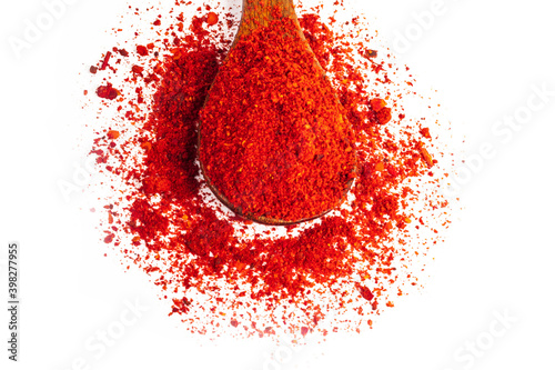 Studio lighting. red paprika spice on a wooden spoon, on a white background. There is a shadow. Close-up. No isolation. photo