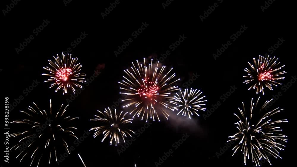4K long shot 39s. loop seamless of real shining fireworks for celebration background. large golden glowing firework during new year's eve countdown festival in the sky display at night with colorful.