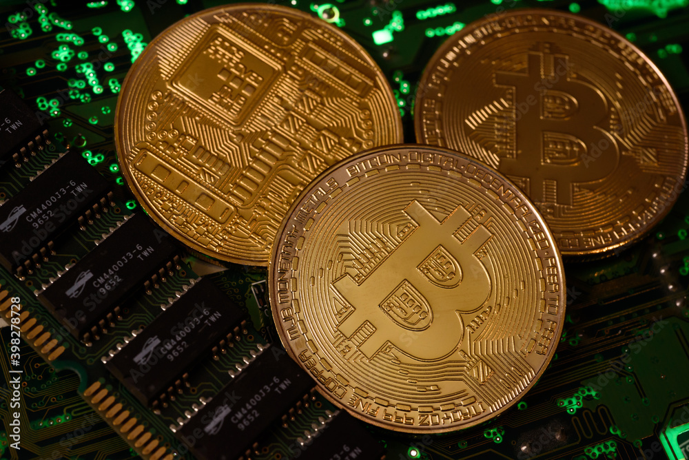 In this photo illustration, Bitcoin cryptocurrency commemorative coins on circuit board. In this photo illustration, Bitcoin cryptocurrency commemorative coins on circuit board.