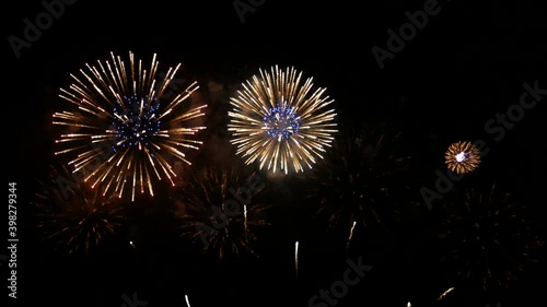 4K long shot 42s. real shining fireworks for celebration background. large golden glowing firework during new year's eve countdown festival in the sky display at night with colorful.