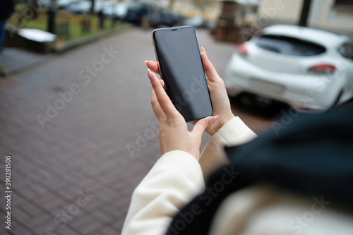 phone in the hands of a girl on the street mockup