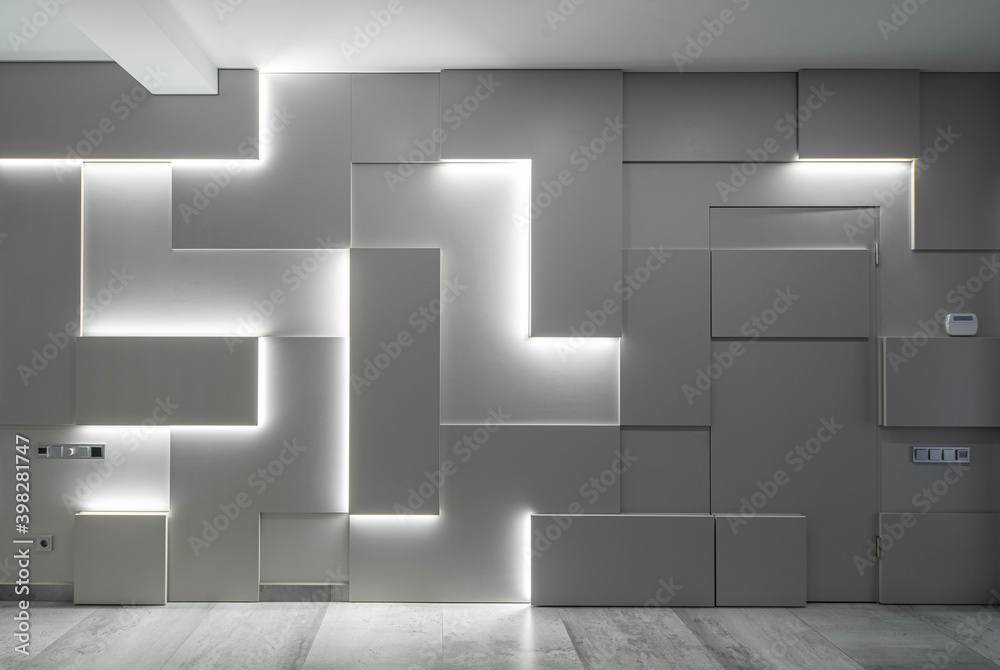 Foto Stock Contemporary interior of luxury apartment. Modern hi-tech  geometric design of wall with lamps. | Adobe Stock