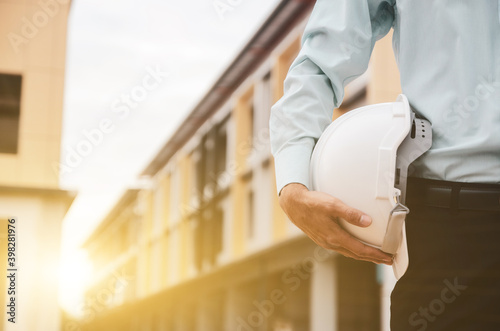 white helmet in the hands of a construction businessman