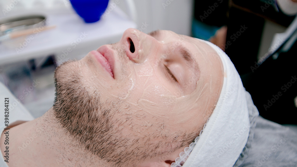 the beautician makes a mask to the patient the beautician makes a mask to the patient