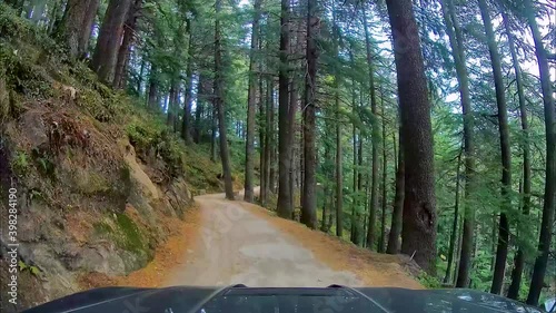 4x4 SUV driving through narrow and dangerous roads of wildlife sanctuary in mountains. View through dash camera. photo