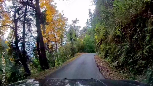 SUV driving through narrow, dangerous and curved mountainous roads. View through dash camera.