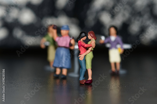 group of miniature gay figures with in the middle a female couple dancing
