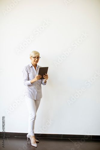 Mature businesswoman using ...