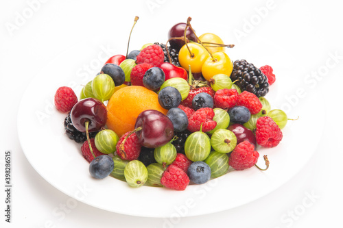 Assorted fresh different berries on a white plate. useful vitamin healthy food fruit. healthy vegetable breakfast