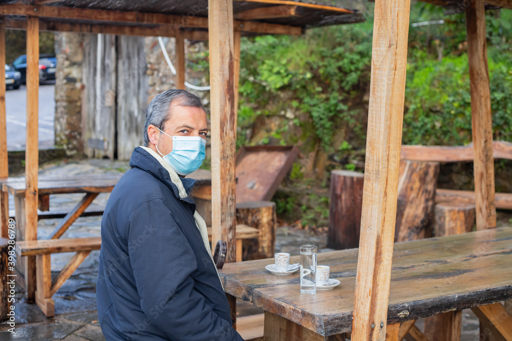 man with mask drinking coffee