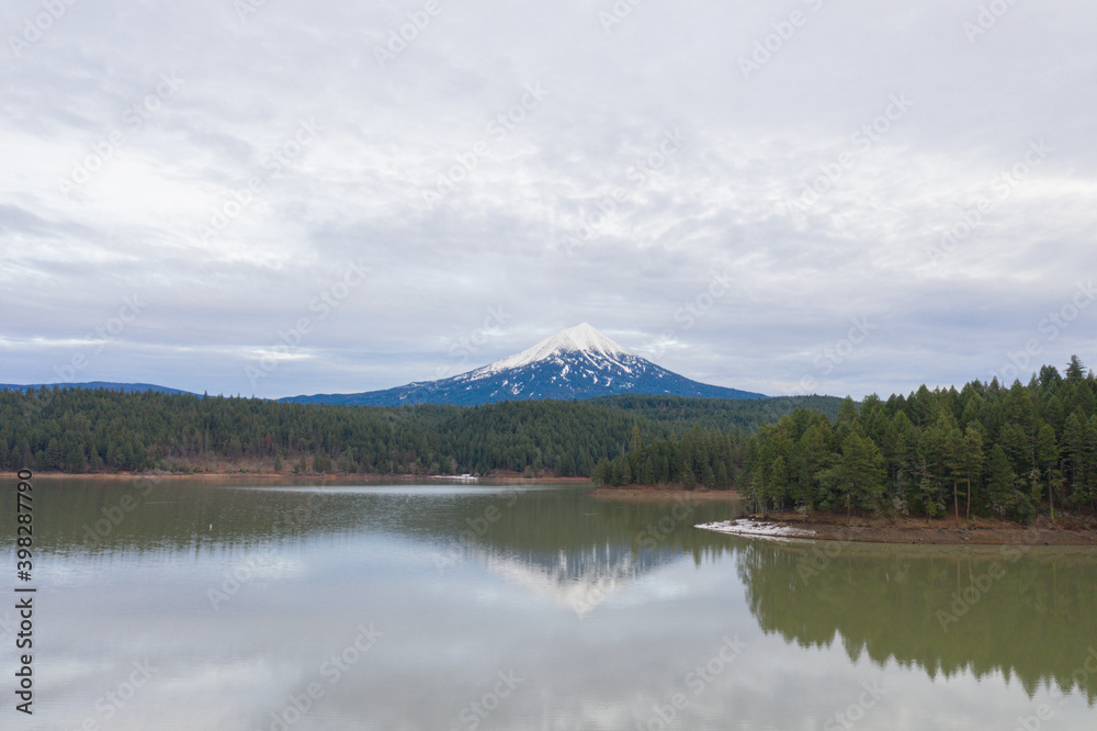 Peaceful lake in the forest with a mountain as background