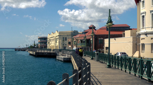 Bridgetown, Barbados - December 2019: Tourists and locals enjoying a beautiful sunny afternoon walk on the famous Boardwalk