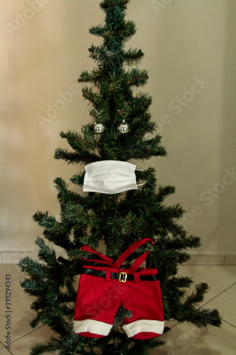 Christmas tree with face mask. Christmas decoration. Coronavirus pandemic Covit-19.