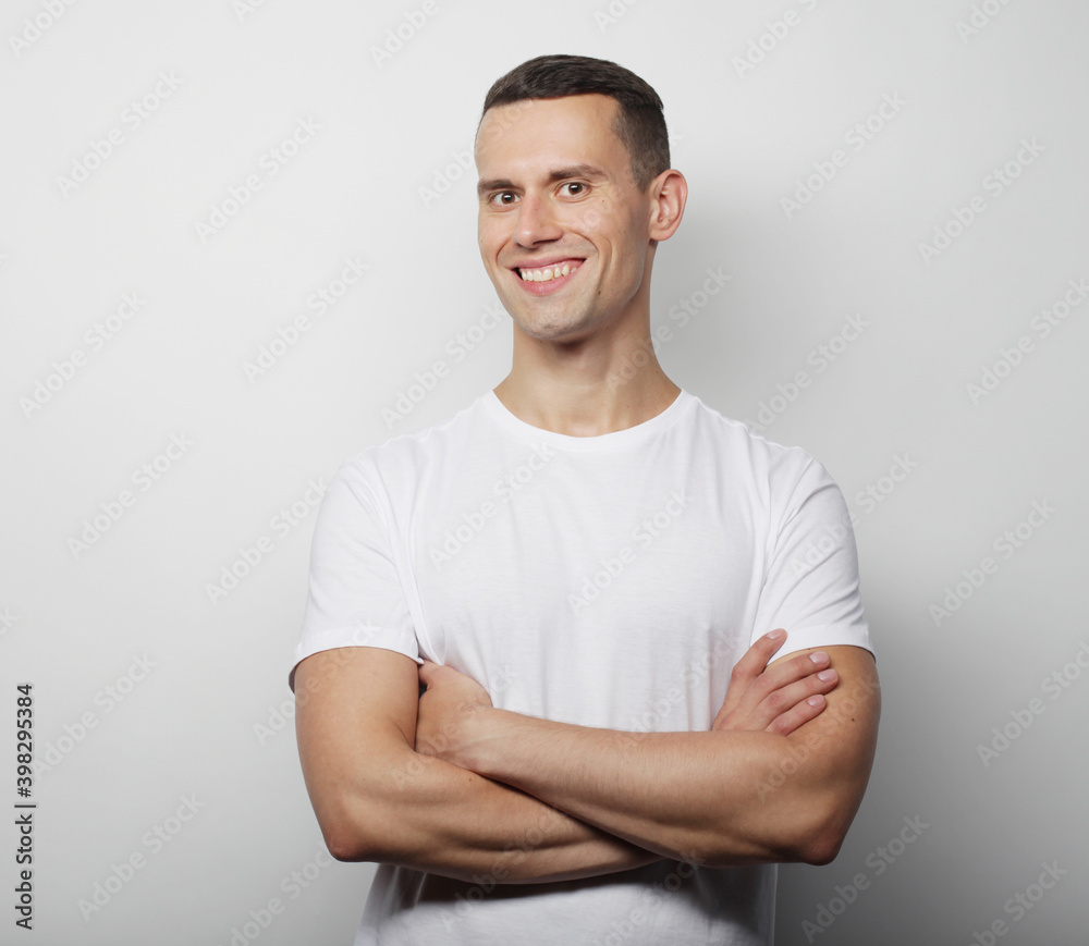 lifestyle and people concept: Portrait of a smart young man wearing casual standing over white background lifestyle and people concept: Portrait of a smart young man wearing casual standing over white background