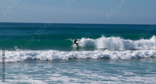 Young surfer riding perfect surf wave at the beach of El Palmar. Spanish Atlantic coast in Cadiz, perfect surfing spot in Europe