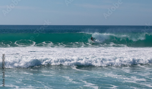 Young surfer riding perfect surf wave at the beach of El Palmar. Spanish Atlantic coast in Cadiz, perfect surfing spot in Europe