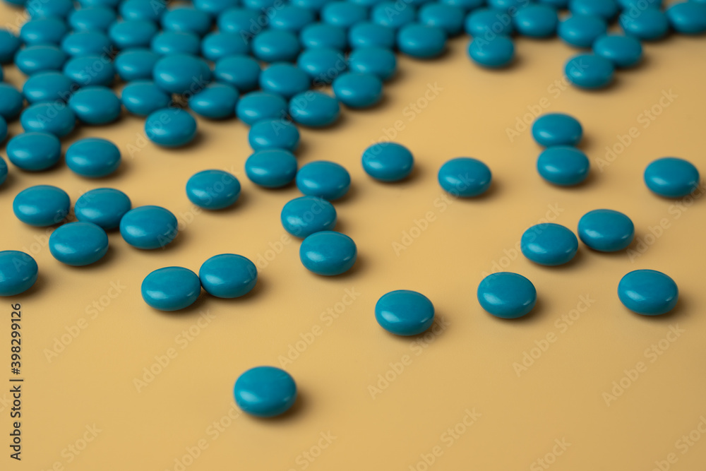 blue pills on beige color background blue pills on beige color background