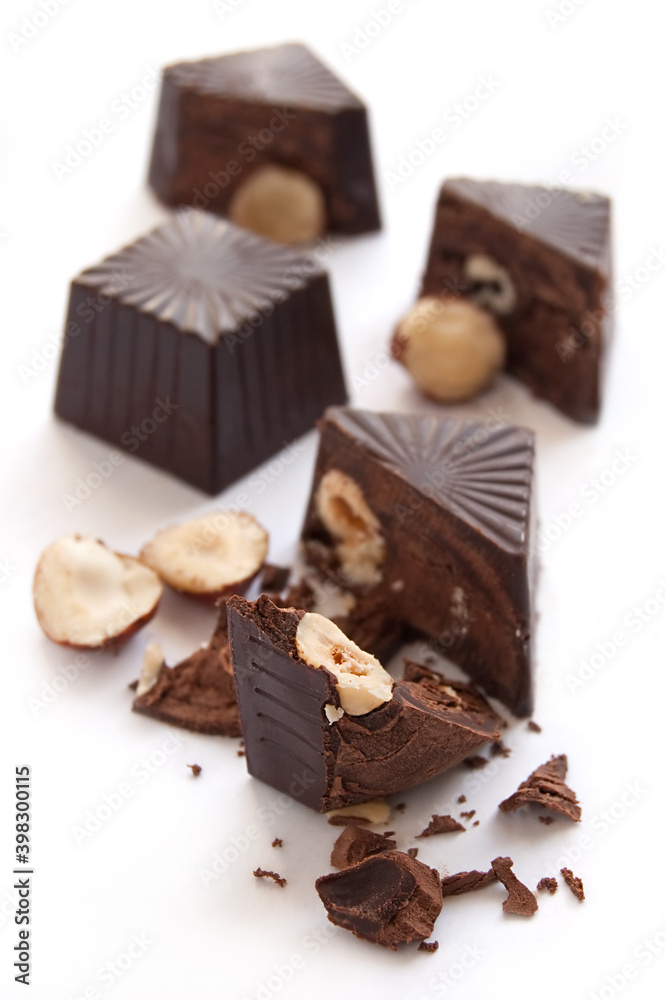 Broken chocolate candies with hazelnut inside Broken chocolate candies with hazelnut inside