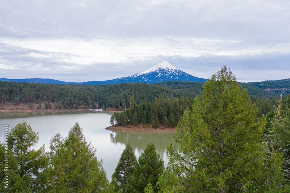 Peaceful lake in the forest with a mountain as background
