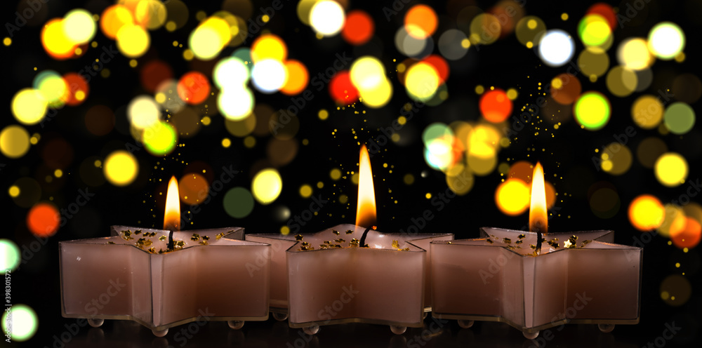 Christmas candles on a black background with bokeh Christmas candles on a black background with bokeh