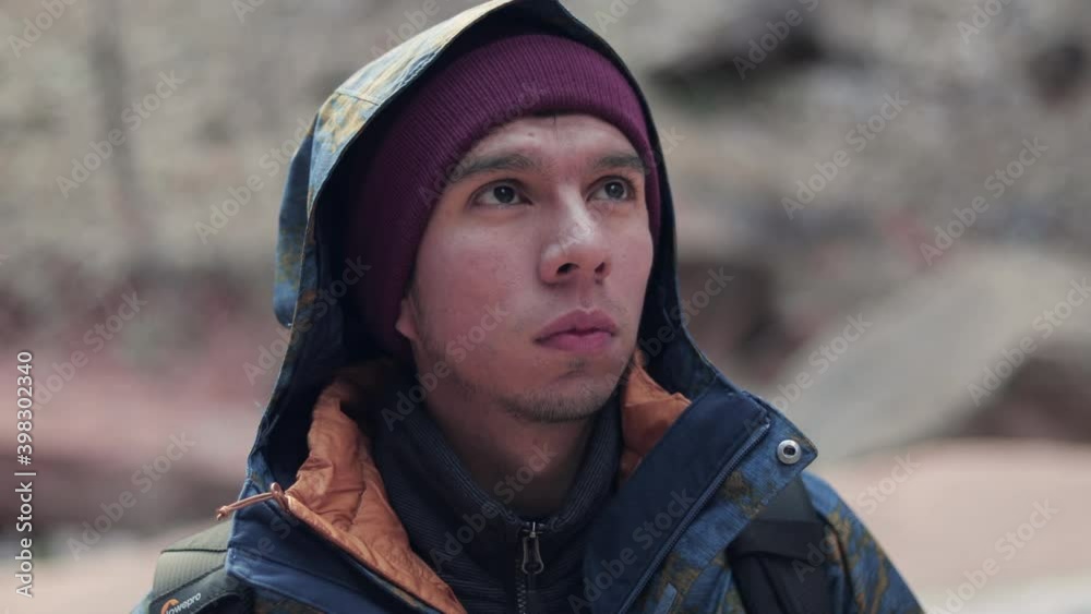 man in hoodie and beanie looking up