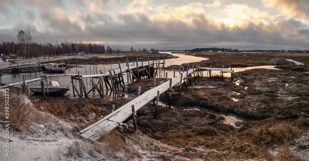Low tide. Fishing pier in the authentic Northern village of Umba. Kola Peninsula