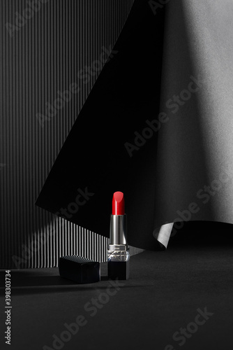 Lipstick. Creative concept of red lipstick on black photo