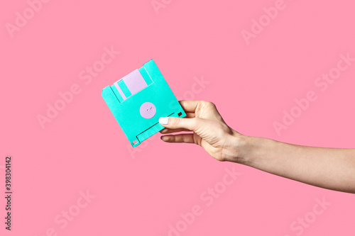 Handmade paper floppy disk in a hand.