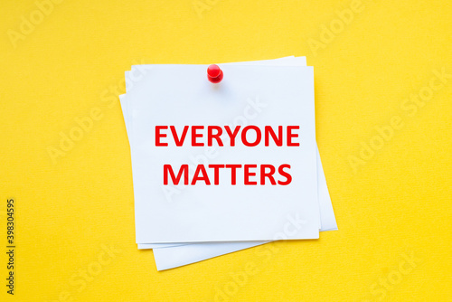 Text everyone matters on white sticker with yellow background