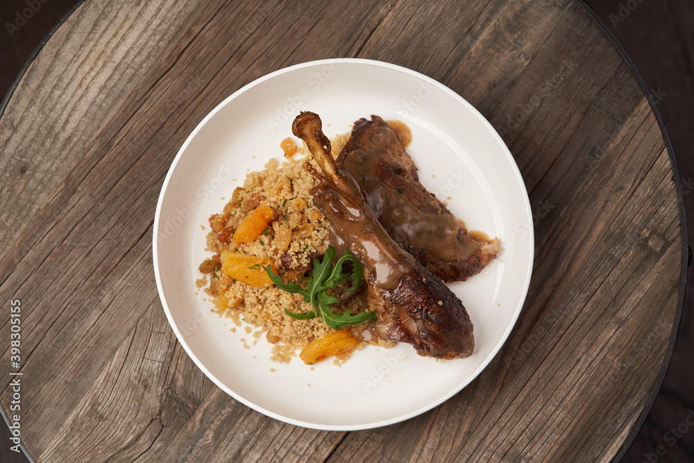 Roasted turkey and couscous on wooden table background Roasted turkey and couscous on wooden table background