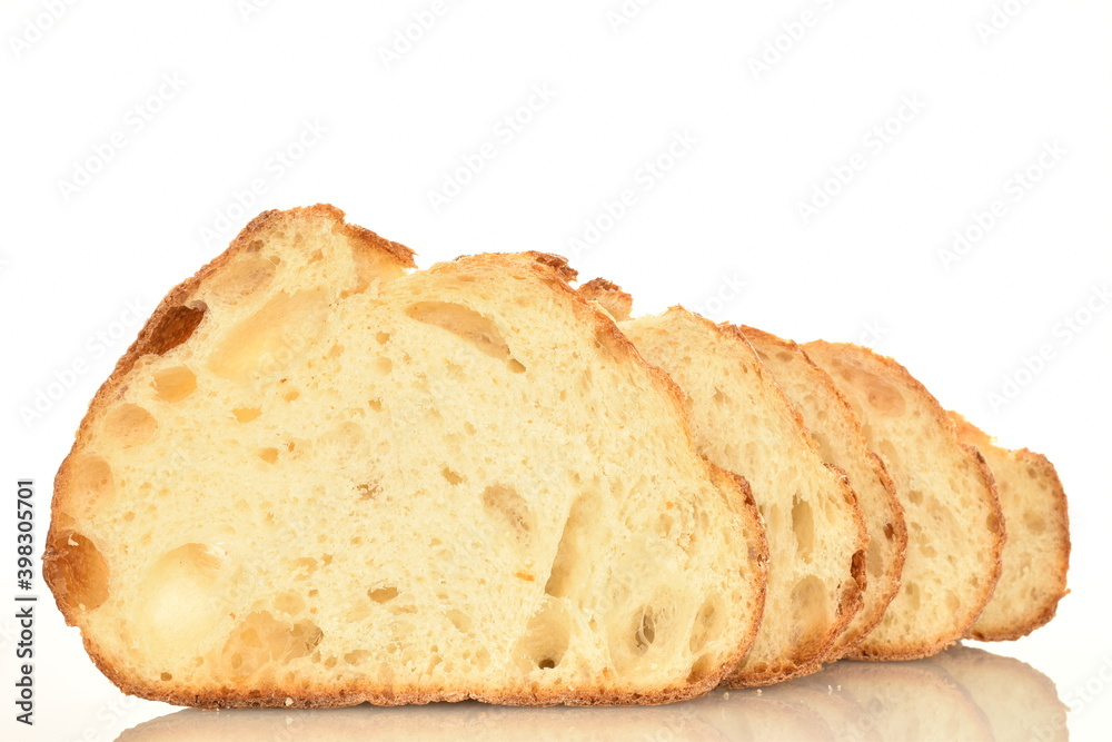 Fragrant French hearth bread sliced into slices, close-up, isolated on white.